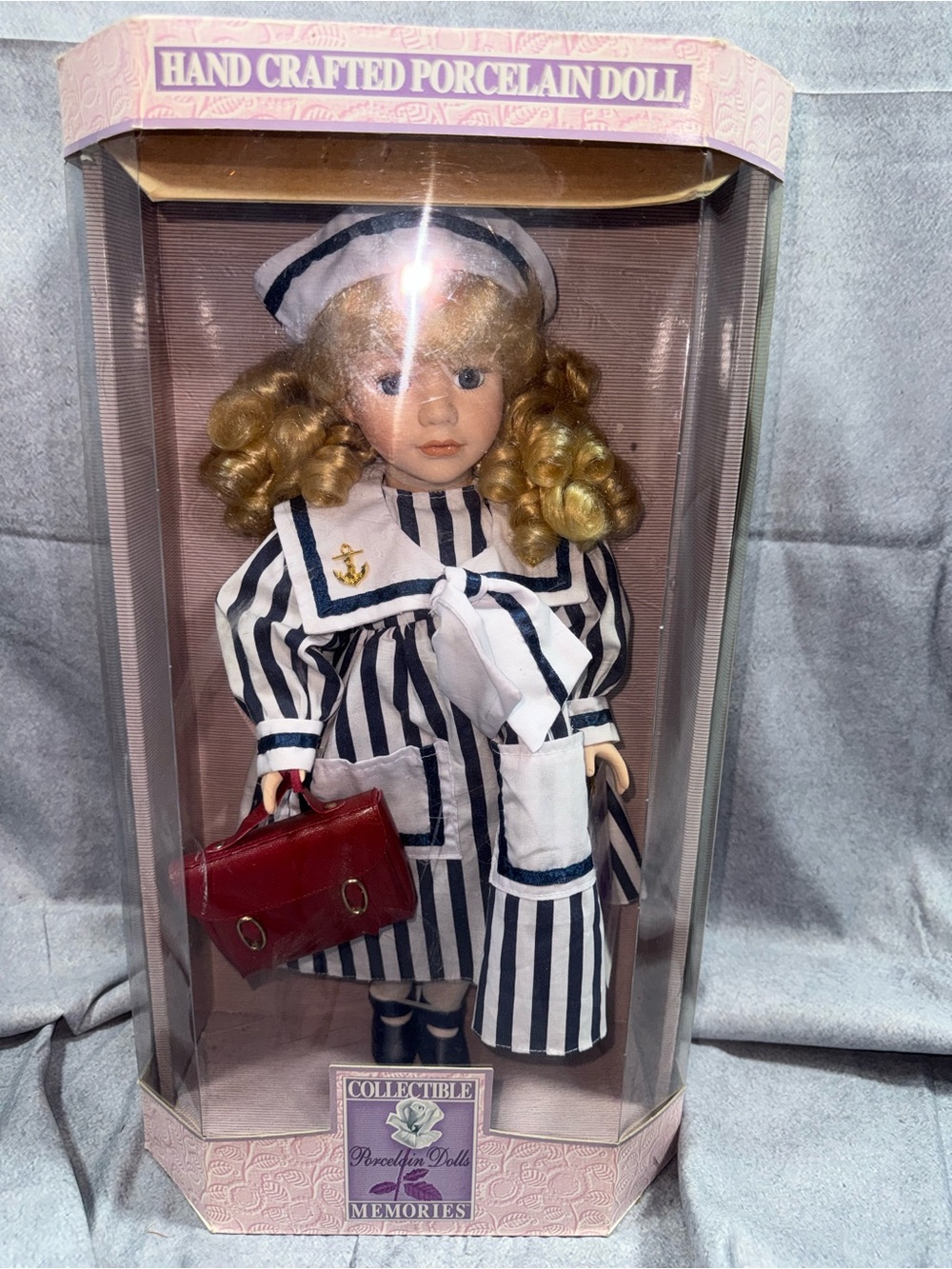 Collectible Porcelain Sailor Doll with Blonde Curls and Red Handbag